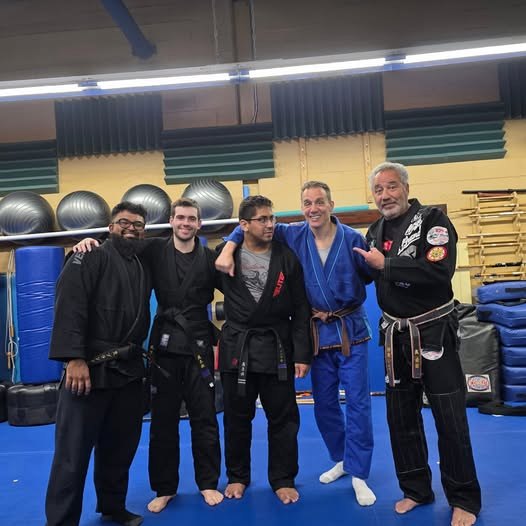 Adult black belts and instructors standing together on the mat at Makoto Jiu Jitsu Centers in Deer Park